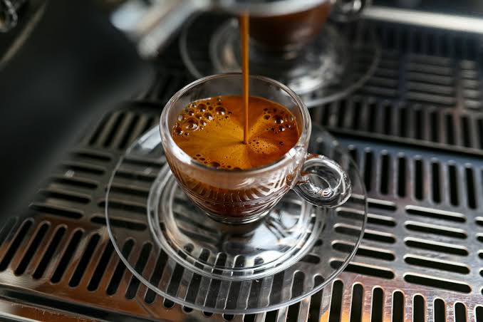 Espresso prism shot pouring with rich crema into a glass cup